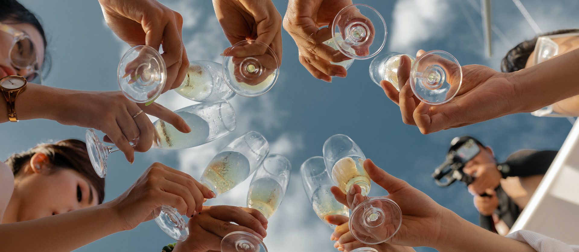 Group of people celebrating with glasses of wine